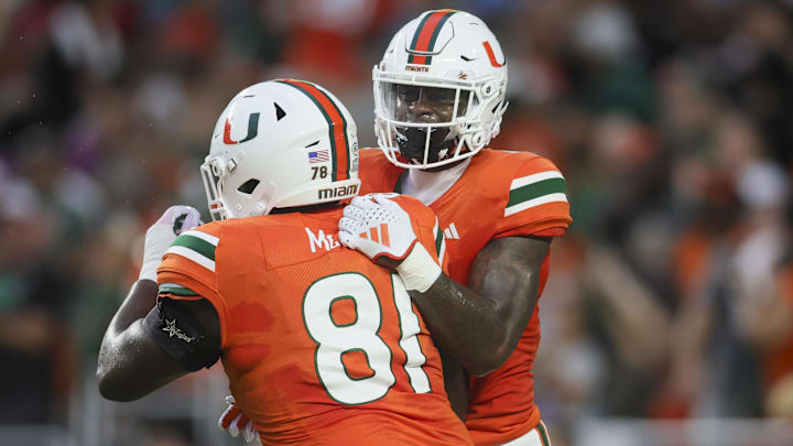 Sep 1, 2023; Miami Gardens, Florida, USA; Miami Hurricanes wide receiver Colbie Young (4) celebrates with offensive lineman Francis Mauigoa (81) after scoring a touchdown against the Miami Redhawks during the first quarter at Hard Rock Stadium. Mandatory Credit: Sam Navarro-Imagn Images