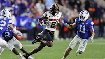Oct 18, 2024; Provo, Utah, USA; Oklahoma State Cowboys wide receiver Talyn Shettron (2) runs the ball defended by Brigham Young Cougars linebacker Harrison Taggart (11) during the third quarter at LaVell Edwards Stadium. Mandatory Credit: Rob Gray-Imagn Images