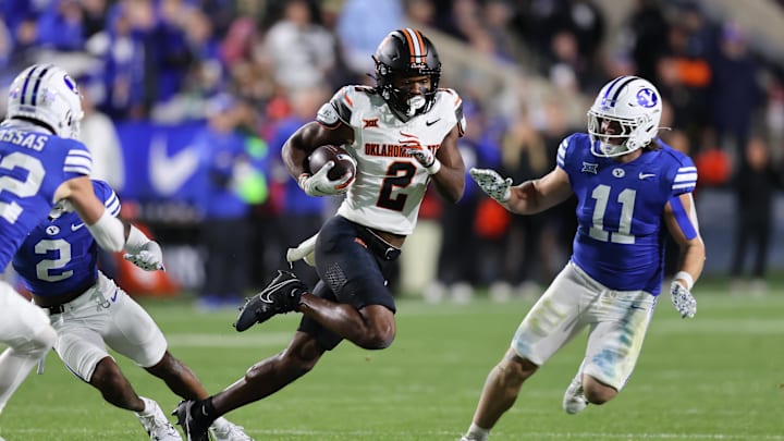 Oct 18, 2024; Provo, Utah, USA; Oklahoma State Cowboys wide receiver Talyn Shettron (2) runs the ball defended by Brigham Young Cougars linebacker Harrison Taggart (11) during the third quarter at LaVell Edwards Stadium. Mandatory Credit: Rob Gray-Imagn Images Oct 18, 2024; Provo, Utah, USA; Oklahoma State Cowboys wide receiver Talyn Shettron (2) runs the ball defended by Brigham Young Cougars linebacker Harrison Taggart (11) during the third quarter at LaVell Edwards Stadium. Mandatory Credit: Rob Gray-Imagn Images