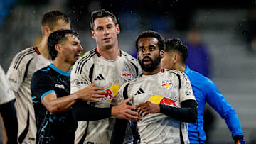 New York Red Bulls defender Raheem Edwards (44) is held back by defender Sean Nealis (15) and Colorado Springs Switchbacks FC midfielder Anthony Fontana (21) 