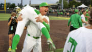 Oregon head coach Mark Wasikowski carries infielder Rikuu Nishida as the Oregon Ducks defeated Oral Roberts University 9-8 in the first game of a best of three NCAA Super Regional series at PK Park in Eugene, Ore. Friday, June 9, 2023.