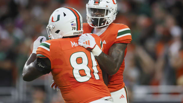 Miami Hurricanes wide receiver Colbie Young (4) celebrates with offensive lineman Francis Mauigoa (81) after scoring a touchd