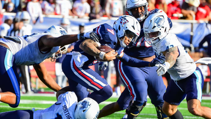 Nov 11, 2023; Lynchburg, Virginia, USA;  Liberty Flames quarterback Kaidon Salter (7) is tackled by Old Dominion Monarchs linebacker Wayne Matthews III (15) and Old Dominion Monarchs linebacker Jason Henderson (42) at Williams Stadium. Mandatory Credit: Brian Bishop-USA TODAY Sports