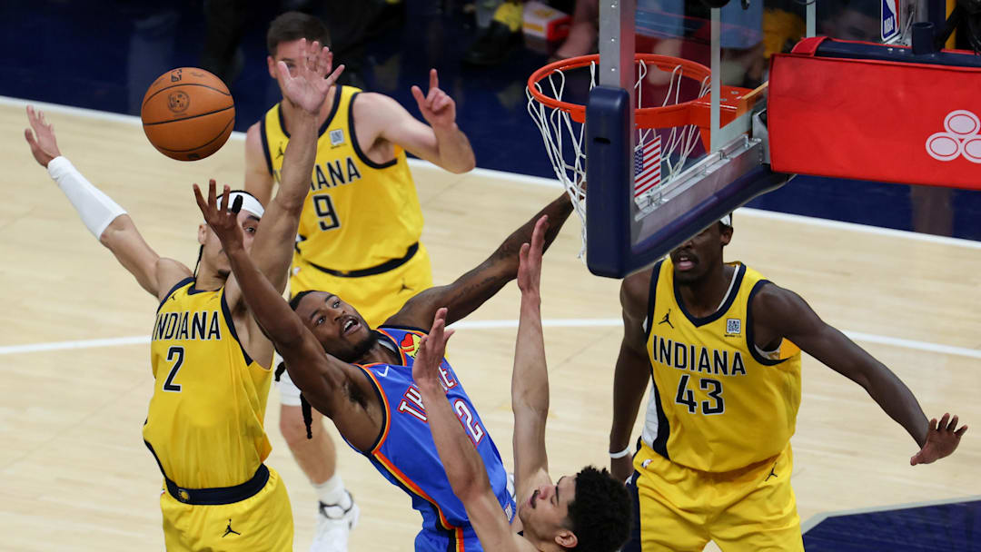 Jun 19, 2025; Indianapolis, Indiana, USA; Oklahoma City Thunder guard Cason Wallace (22) shoots the ball defended by Indiana Pacers guard Andrew Nembhard (2) and guard Ben Sheppard (26) in the fourth quarter during game six of the 2025 NBA Finals at Gainbridge Fieldhouse. Mandatory Credit: Trevor Ruszkowski-Imagn Images