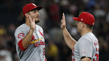Jul 23, 2024; Pittsburgh, Pennsylvania, USA;  St. Louis Cardinals third baseman Nolan Arenado (28) and relief pitcher Ryan Helsley (56) celebrate after defeating the Pittsburgh Pirates at PNC Park. St. Louis won 2-1. Mandatory Credit: Charles LeClaire-Imagn Images