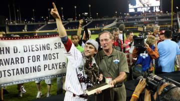 Former South Carolina baseball second baseman Scott Wingo posing with the College World Series trophy