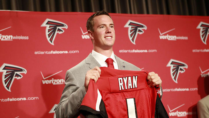 April 27, 2008; Flowery Branch, GA, USA; Atlanta Falcons first round draft pick quarterback Matt Ryan poses with a Falcons jersey during the press conference introducing him at the Falcons Training Complex. Mandatory Credit: Dale Zanine Imagn Images