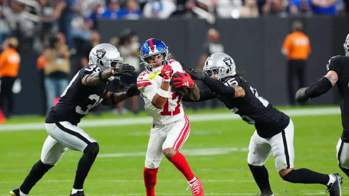 Nov 5, 2023; Paradise, Nevada, USA; New York Giants wide receiver Wan'Dale Robinson (17) is defended by Las Vegas Raiders cornerback Nate Hobbs (39) and safety Tre'von Moehrig (25) during the fourth quarter at Allegiant Stadium. Mandatory Credit: Stephen R. Sylvanie-USA TODAY Sports