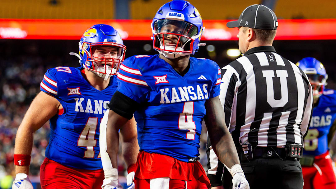 Nov 23, 2024; Kansas City, Missouri, USA;  Kansas running back Devin Neal (4) reacts after scoring a touchdown during the 3rd quarter between the Kansas Jayhawks and the Colorado Buffaloes at GEHA Field at Arrowhead Stadium. Mandatory Credit: Nick Tre. Smith-Imagn Images