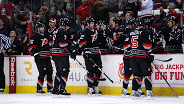 April 7, 2009; Raleigh, NC, USA; Carolina Hurricanes center (12) Eric Staal is congratulated by his teammates after his 1st period goal against the New York Islanders at the RBC Center. Mandatory Credit: James Guillory-Imagn Images