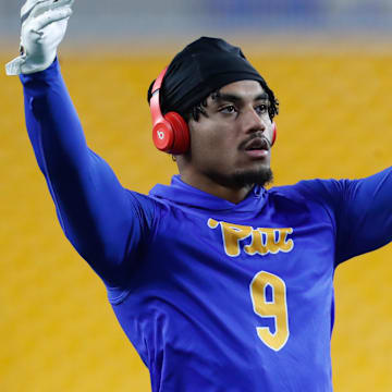 Nov 16, 2023; Pittsburgh, Pennsylvania, USA;  Pittsburgh Panthers defensive back A.J. Woods (9) warms up before the game against the Boston College Eagles at Acrisure Stadium. Mandatory Credit: Charles LeClaire-Imagn Images