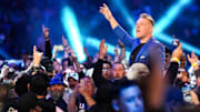 Pat McAfee enters the stadium and greets the crowd Saturday, Feb. 1, 2025, during the WWE Royal Rumble at Lucas Oil Stadium in Indianapolis.