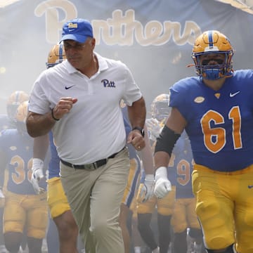 Aug 31, 2024; Pittsburgh, Pennsylvania, USA;  Pittsburgh Panthers defensive back Donovan McMillon (3) and head coach Pat Narduzzi and Pittsburgh Panthers offensive lineman Ryan Jacoby (61) lead the team onto the field against the Kent State Golden Flashes at Acrisure Stadium.