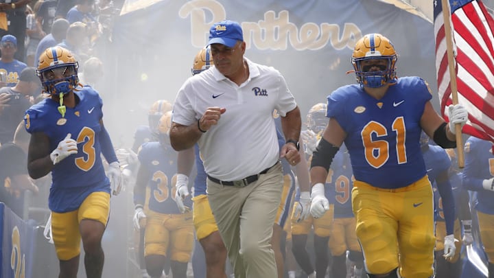 Aug 31, 2024; Pittsburgh, Pennsylvania, USA;  Pittsburgh Panthers defensive back Donovan McMillon (3) and head coach Pat Narduzzi and Pittsburgh Panthers offensive lineman Ryan Jacoby (61) lead the team onto the field against the Kent State Golden Flashes at Acrisure Stadium.