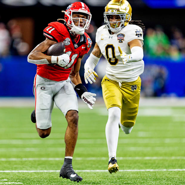 Arian Smith (11) runs with the ball