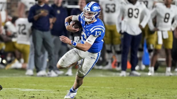 Riley Leonard runs for yardage against Notre Dame, while still at Duke in 2023.