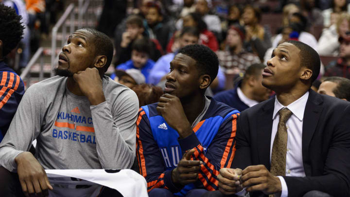 Jan 25, 2014; Philadelphia, PA, USA; Oklahoma City Thunder forward Kevin Durant (35) guard Royal Ivey (7) and guard Russell Westbrook (0) (left to right) watch from the bench during the fourth quarter against the Philadelphia 76ers at the Wells Fargo Center. The Thunder defeated the Sixers 103-91. Mandatory Credit: Howard Smith-USA TODAY Sports