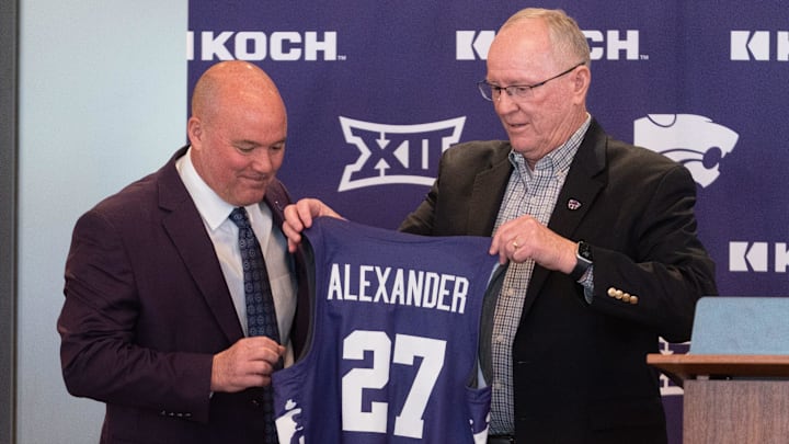 Casey Alexander is given a jersey by Kansas State Athletic Director Gene Taylor as he's welcomed as the new head coach of the Kansas State men’s basketball team during a press conference at Bramlage Coliseum on Monday, March 16, 2026.