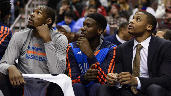 Jan 25, 2014; Philadelphia, PA, USA; Oklahoma City Thunder forward Kevin Durant (35) guard Royal Ivey (7) and guard Russell Westbrook (0) (left to right) watch from the bench during the fourth quarter against the Philadelphia 76ers at the Wells Fargo Center. The Thunder defeated the Sixers 103-91. Mandatory Credit: Howard Smith-USA TODAY Sports