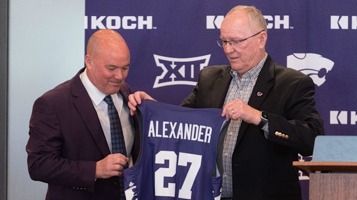 Casey Alexander is given a jersey by Kansas State Athletic Director Gene Taylor as he's welcomed as the new head coach of the Kansas State men’s basketball team during a press conference at Bramlage Coliseum on Monday, March 16, 2026.