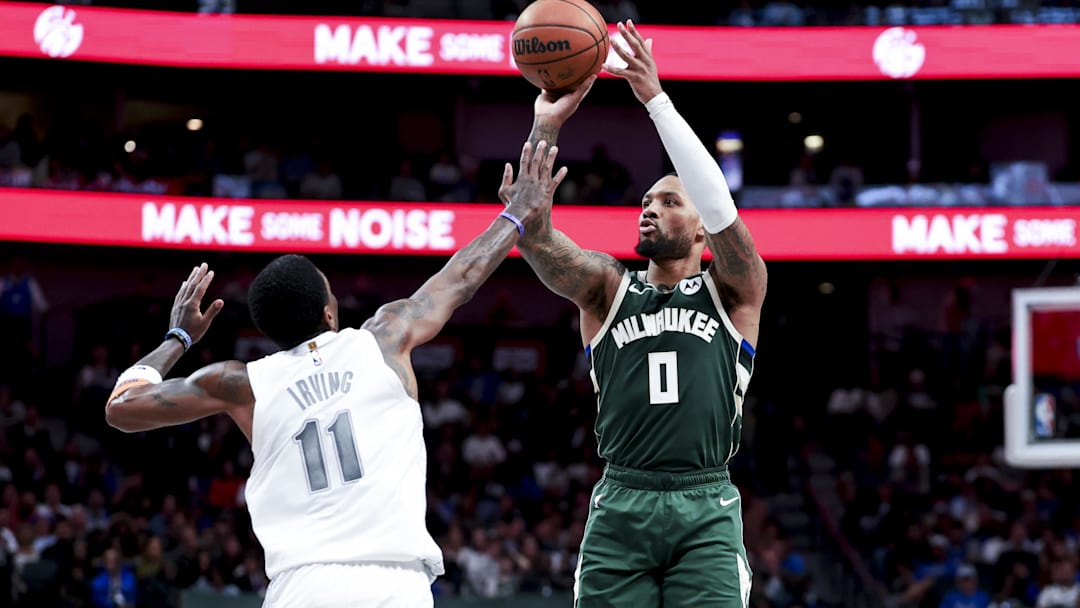 Mar 1, 2025; Dallas, Texas, USA;  Milwaukee Bucks guard Damian Lillard (0) shoots over Dallas Mavericks guard Kyrie Irving (11) during the second half at American Airlines Center. Mandatory Credit: Kevin Jairaj-Imagn Images