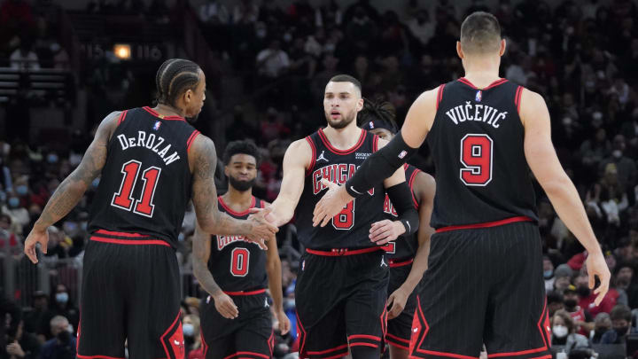 Chicago Bulls guard Zach LaVine (8) celebrates a three point basket against the Indiana Pacers with forward DeMar DeRozan (11) and center Nikola Vucevic (9) during the second half at United Center. Mandatory Credit: