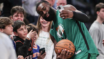 Boston Celtics guard Jaylen Brown (7) poses for photos with fans before the start of the game against the New York Knicks at Madison Square Garden.