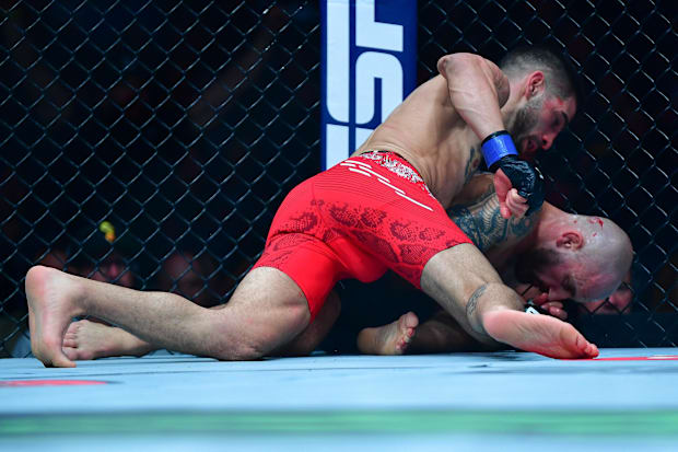 Ilia Topuria lands hits against Alexander Volkanovski for his KO victory during UFC 298 at Honda Center. 