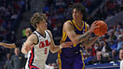Jan 11, 2025; Oxford, Mississippi, USA; LSU Tigers guard Dji Bailey (4) handles the ball as Mississippi Rebels guard Eduardo Klafke (8) defends during the first half at The Sandy and John Black Pavilion at Ole Miss. Mandatory Credit: Petre Thomas-Imagn Images