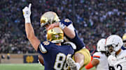 Nov 16, 2024; South Bend, Indiana, USA; Notre Dame Fighting Irish tight end Mitchell Evans (88) and quarterback Riley Leonard (13) celebrate after a touchdown in the second quarter against the Virginia Cavaliers at Notre Dame Stadium. 