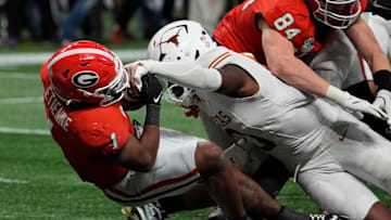 Georgia running back Trevor Etienne powers past Texas linebacker Anthony Hill Jr.