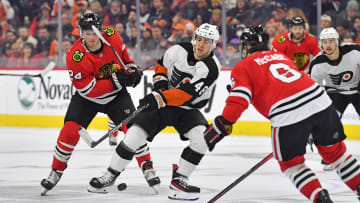 Jan 19, 2023; Philadelphia, Pennsylvania, USA; Philadelphia Flyers center Morgan Frost (48) battle for the puck with Chicago Blackhawks center Sam Lafferty (24) and defenseman Jake McCabe (6) during the third period at Wells Fargo Center. Mandatory Credit: Eric Hartline-USA TODAY Sports