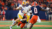 Oct 18, 2025; Syracuse, New York, USA; Pittsburgh Panthers quarterback Mason Heintschel (6) runs with the ball as Syracuse Orange defensive back Braheem Long Jr. (0) defends during the first half at the JMA Wireless Dome. Mandatory Credit: Rich Barnes-Imagn Images