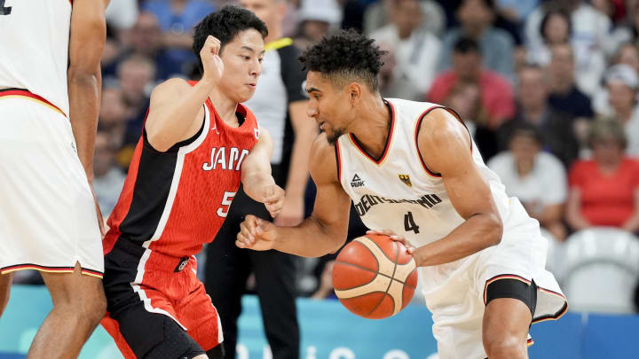 Jul 27, 2024; Villeneuve-d'Ascq, France; Germany point guard Maodo Lo (4) works to move past Japan point guard Yuki Kawamura (5) during the Paris 2024 Olympic Summer Games at Stade Pierre-Mauroy.