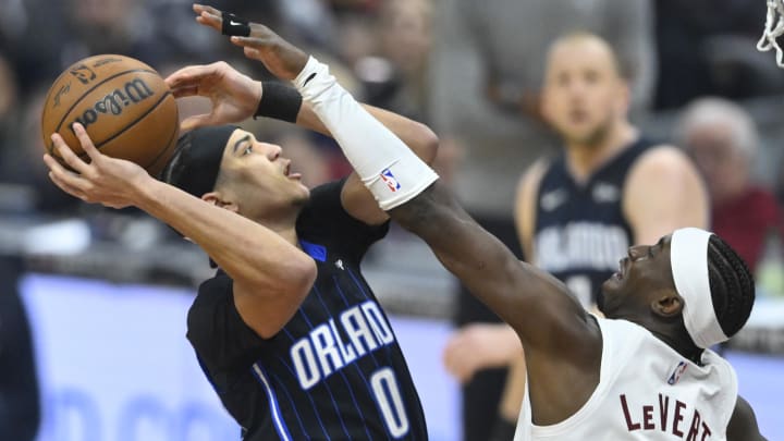 Orlando Magic guard Anthony Black (0) drives to the basket beside Cleveland Cavaliers guard Caris LeVert (3) in the first quarter at Rocket Mortgage FieldHouse. 