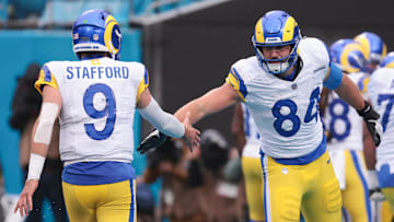 Nov 30, 2025; Charlotte, North Carolina, USA; Los Angeles Rams tight end Colby Parkinson (84) celebrates with Los Angeles Rams quarterback Matthew Stafford (9) during the fourth quarter against the Carolina Panthers at Bank of America Stadium. Mandatory Credit: Scott Kinser-Imagn Images