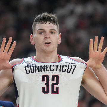 Apr 8, 2024; Glendale, AZ, USA; Connecticut Huskies center Donovan Clingan (32) celebrates defeating the Purdue Boilermakers in the national championship game of the Final Four of the 2024 NCAA Tournament at State Farm Stadium. Mandatory Credit: Robert Deutsch-USA TODAY Sports