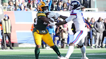 Nov 16, 2025; East Rutherford, New Jersey, USA; Green Bay Packers running back Emanuel Wilson (23) scores a touchdown against New York Giants cornerback Deonte Banks (2) during the second quarter at MetLife Stadium. Mandatory Credit: Robert Deutsch-Imagn Images