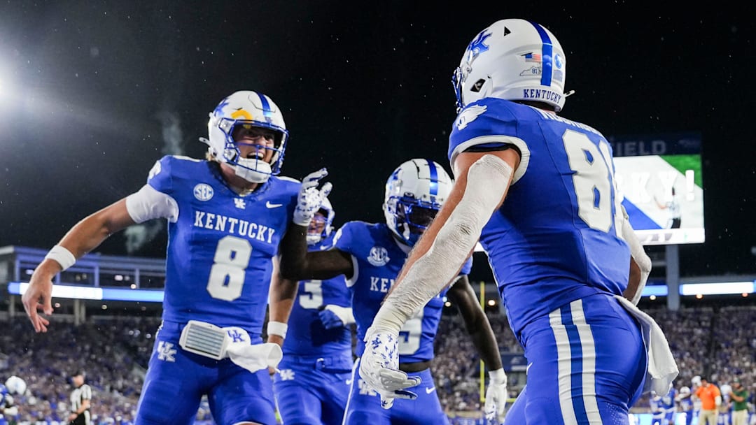 Kentucky Wildcats quarterback Cutter Boley (8), left, celebrates his touchdown pass to Kentucky Wildcats tight end Willie Rodriguez (81) in the second quarter as the Wildcats are rolling in the football game against Eastern Michigan at Kroger Field in Lexington, Kentucky Saturday, Sept. 13, 2025.