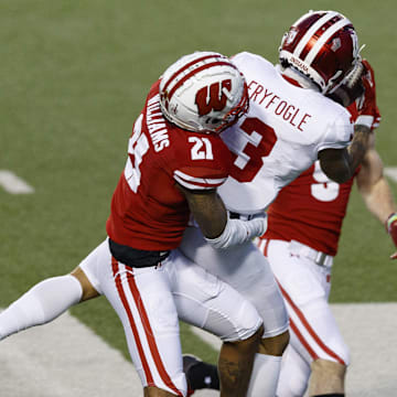 Dec 5, 2020; Madison, Wisconsin, USA;  Indiana Hoosiers wide receiver Ty Fryfogle (3) catches a pass between Wisconsin Badgers cornerback Caesar Williams (21) and safety Scott Nelson (9) during the third quarter at Camp Randall Stadium.
