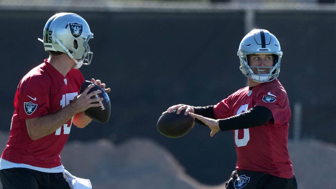 Jun 9, 2026; Henderson, NV, USA; Las Vegas Raiders quarterbacks Fernando Mendoza (15) and Kirk Cousins (8) throw the ball as assistant head coach Mike McCoy (left) watches during minicamp at Intermountain Health Performance Center. Mandatory Credit: Kirby Lee-Imagn Images