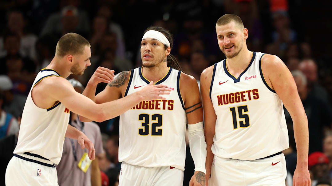 Mar 24, 2026; Phoenix, Arizona, USA; Denver Nuggets guard Christian Braun (0) celebrates with forward Aaron Gordon (32) and center Nikola Jokic (15) against the Phoenix Suns in the first half at Mortgage Matchup Center. Mandatory Credit: Mark J. Rebilas-Imagn Images
