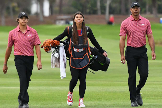 Tiger Woods, Sam Woods, and Charlie Woods approach the 18th green during the 2024 PNC Championship.