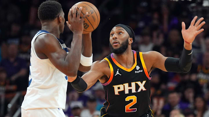 Apr 28, 2024; Phoenix, Arizona, USA; Phoenix Suns forward Josh Okogie (2) guards Minnesota Timberwolves guard Anthony Edwards (5) during the second half of game four of the first round for the 2024 NBA playoffs at Footprint Center. Mandatory Credit: Joe Camporeale-Imagn Images