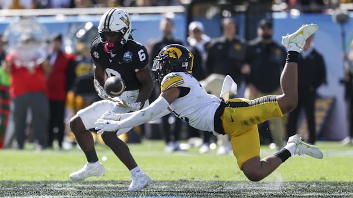 Dec 31, 2025; Tampa, FL, USA; Iowa Hawkeyes defensive back TJ Hall (2) breaks up a pass to Vanderbilt Commodores wide receiver Tre Richardson (6) in the second quarter during the ReliaQuest Bowl at Raymond James Stadium. Mandatory Credit: Nathan Ray Seebeck-Imagn Images