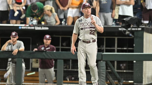 Jun 24, 2024; Omaha, NE, USA;  Texas A&M Aggies head coach Jim Schlossnagle signals the umpire against the Tennessee Volunteers during the ninth inning at Charles Schwab Field Omaha. Mandatory Credit: Steven Branscombe-USA TODAY Sports