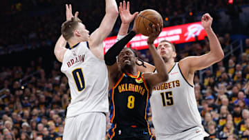 May 5, 2025; Oklahoma City, Oklahoma, USA; Oklahoma City Thunder forward Jalen Williams (8) drives between Denver Nuggets guard Christian Braun (0) and center Nikola Jokic (15) during the second half during game one of the second round for the 2025 NBA Playoffs at Paycom Center. Mandatory Credit: Alonzo Adams-Imagn Images
