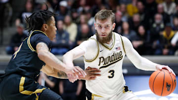 Northwestern Wildcats guard K.J. Windham (24) defends Purdue Boilermakers guard Braden Smith (3) 