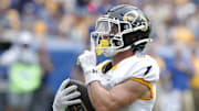 Aug 31, 2024; Pittsburgh, Pennsylvania, USA;  Kent State Golden Flashes wide receiver Luke Floriea (0) gestures to the Pittsburgh Panthers student section after scoring a touchdown during the first quarter at Acrisure Stadium. Mandatory Credit: Charles LeClaire-Imagn Images