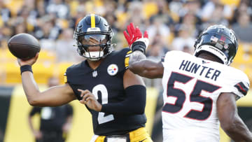 Aug 9, 2024; Pittsburgh, Pennsylvania, USA;  Pittsburgh Steelers quarterback Justin Fields (2) passes against pressure from Houston Texans defensive end Danielle Hunter (55) during the first quarter at Acrisure Stadium. Mandatory Credit: Charles LeClaire-USA TODAY Sports